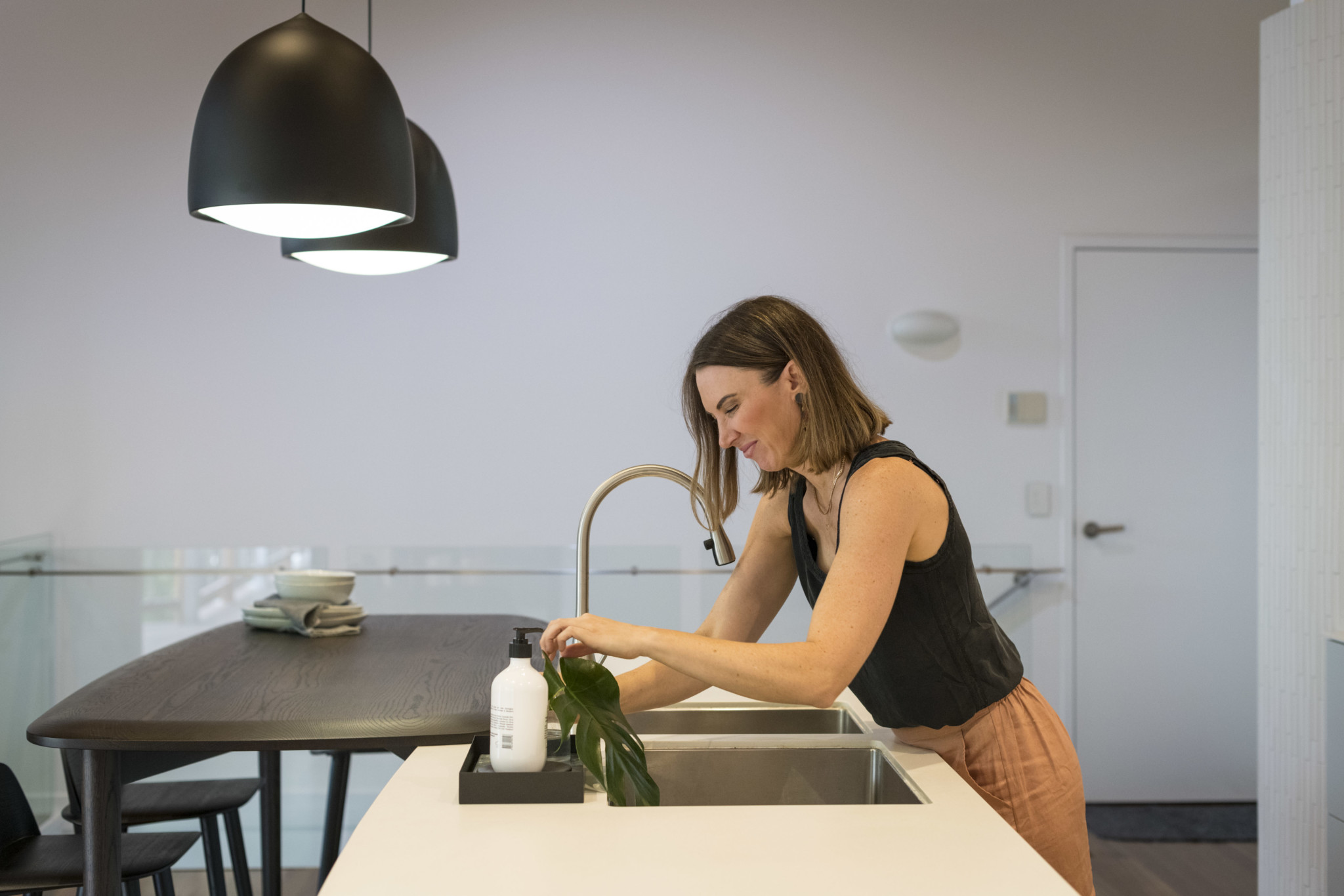 kitchen sink with plant beside on it