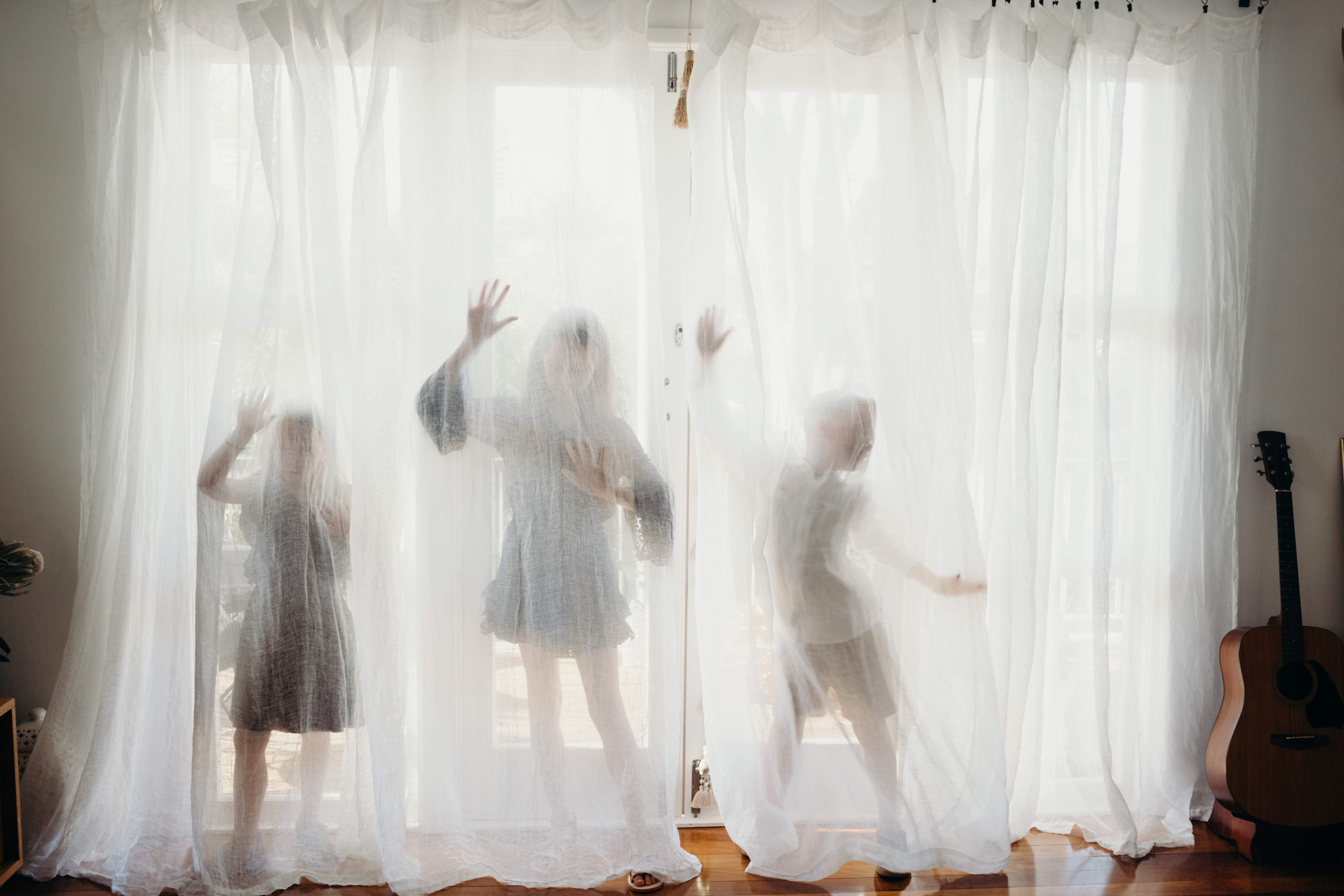 kids behind the curtain