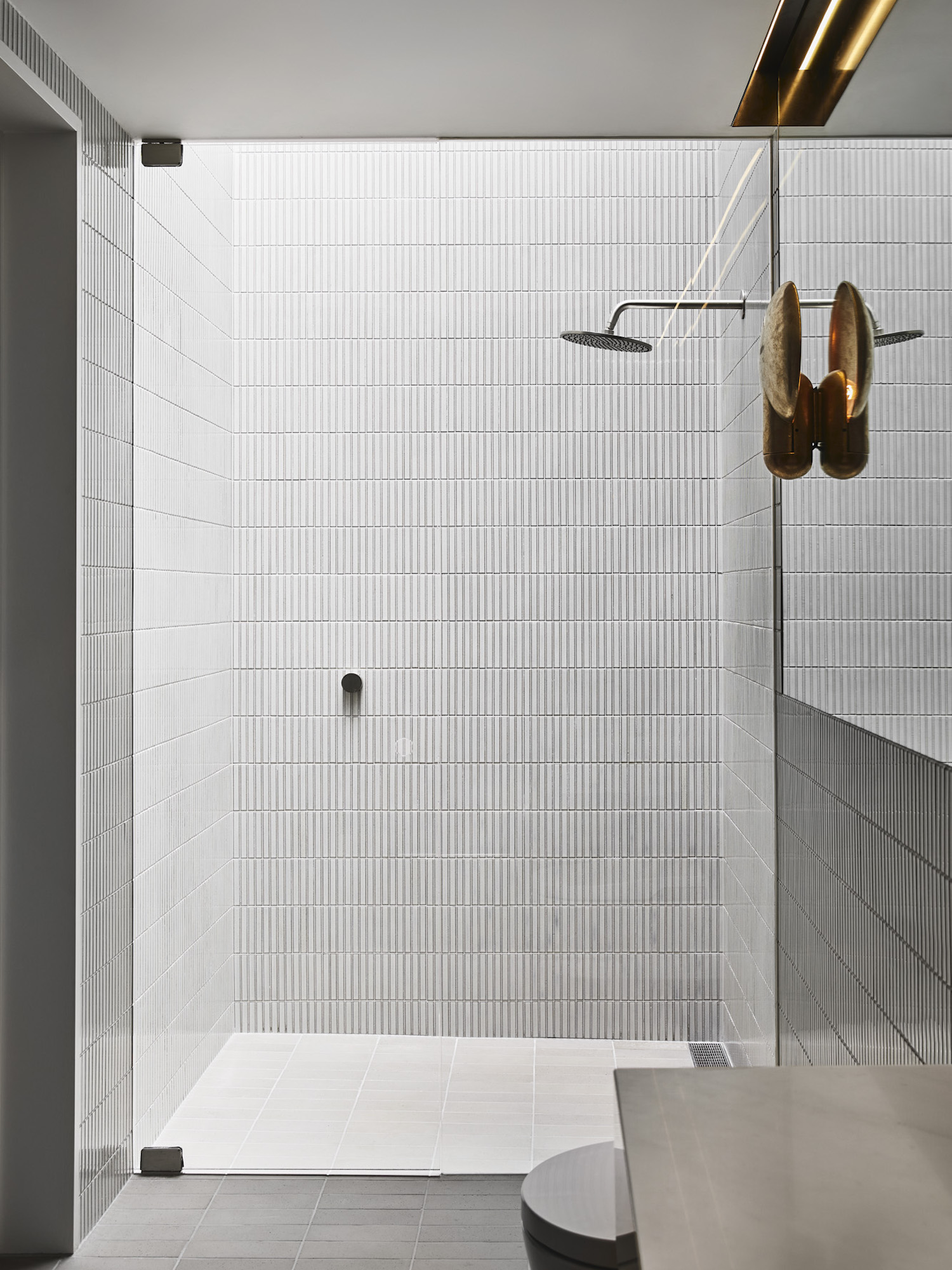 Design by Golden - by having the tiles stack vertically it draws your eye up to the skylight.